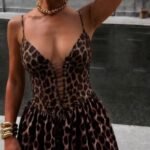 Mini dress with leopard print, triangular design on the chest, lace detail and drawstring waist