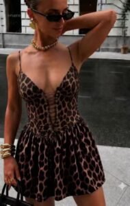 Mini dress with leopard print, triangular design on the chest, lace detail and drawstring waist