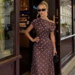 Women's dress with polka dot pattern and boat neckline, with drape
